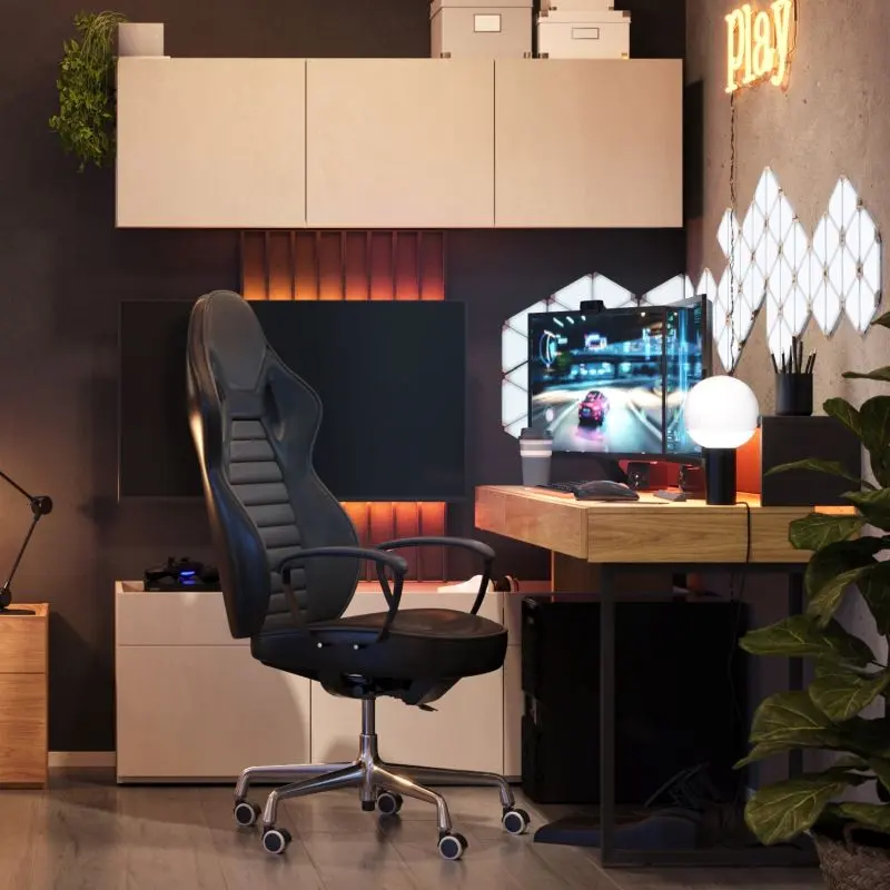 Gaming desk with a metal leg, wall-mounted cabinets, and a TV panel in a modern gaming room setup